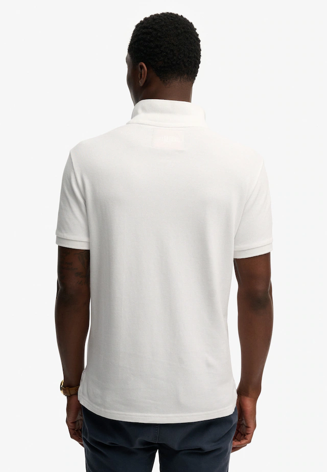 Superdry Poloshirt »CREST POLO« mit Markenlabel, aus Baumwolle, Relaxed Fit, bedruckte Optik